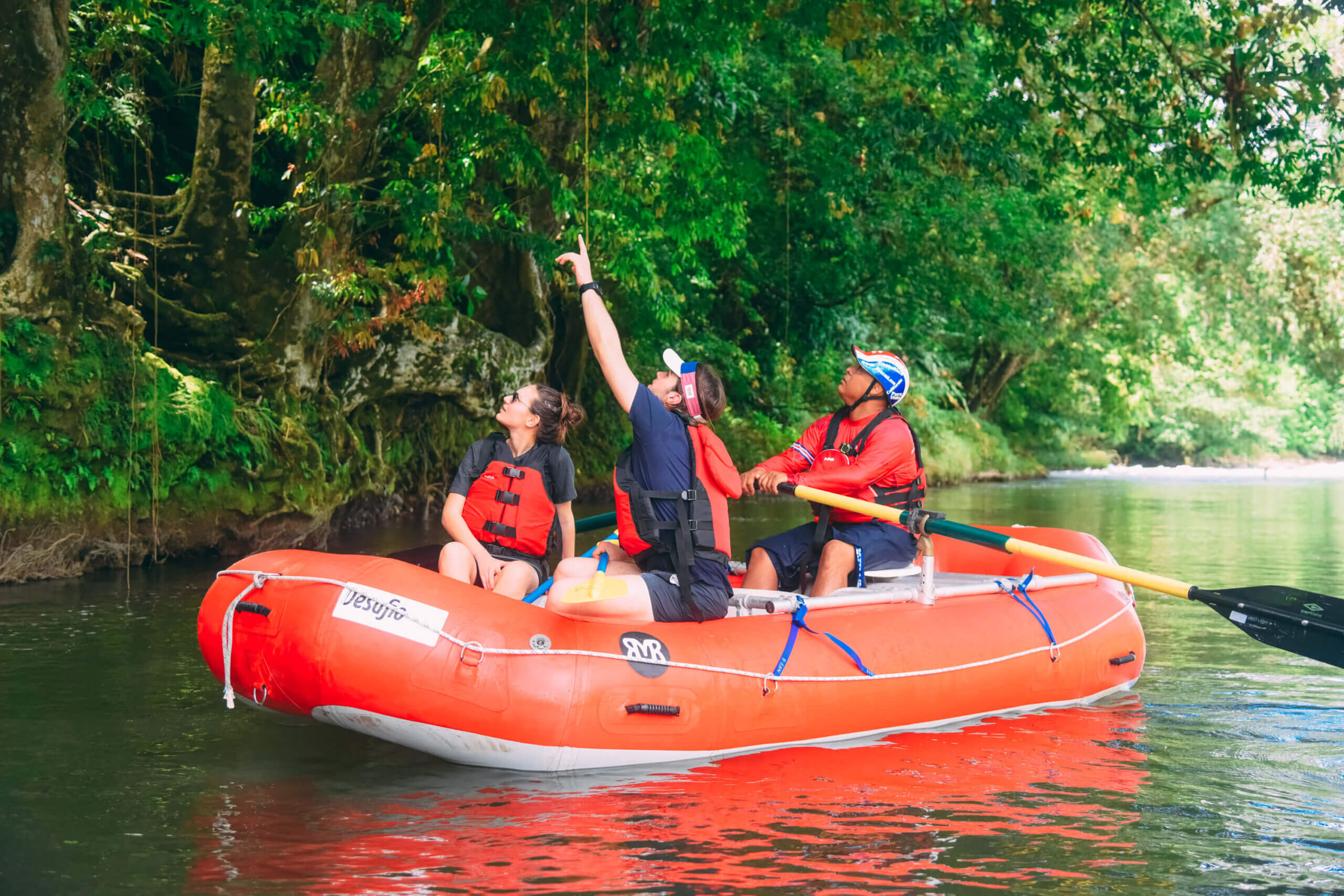 Travelers exploring the rainforest on a safari float